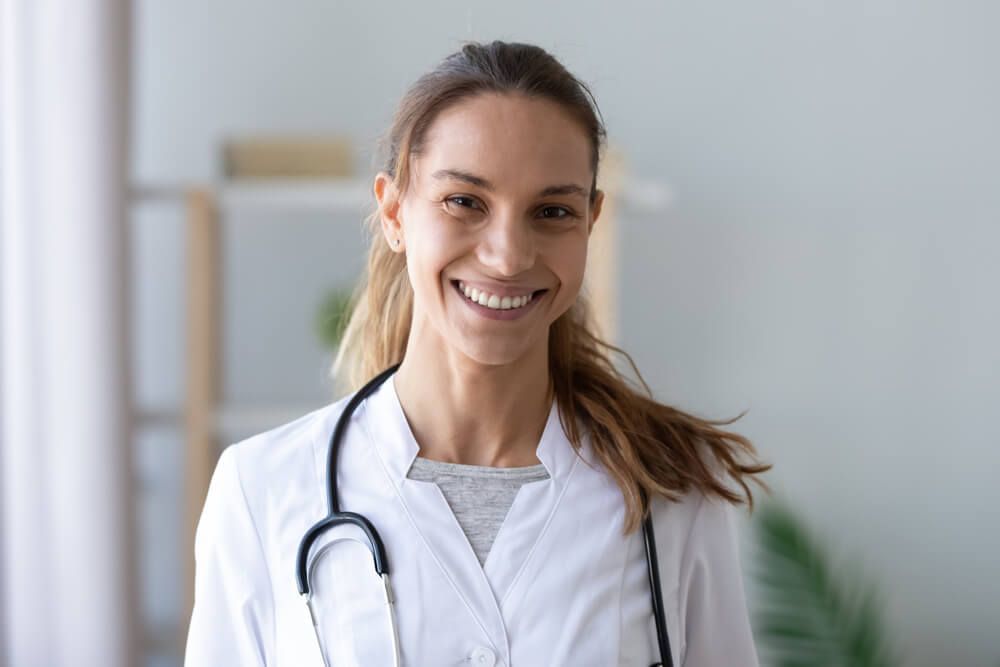 Head shot portrait smiling mixed race female doctor