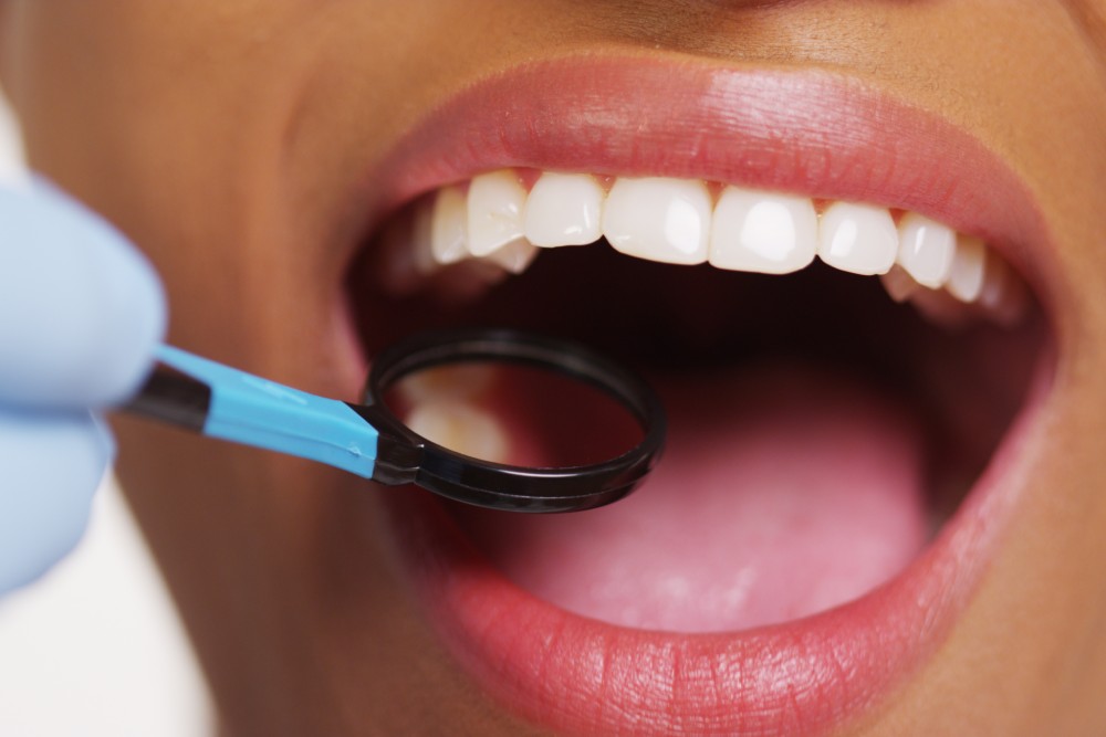 Close up of smiling black woman at dentist