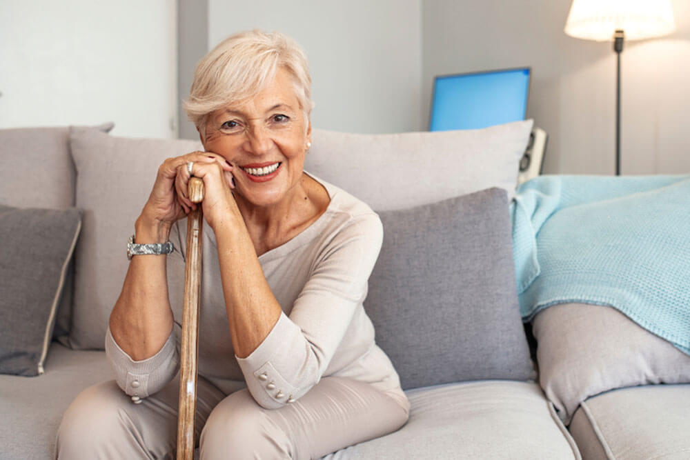 Smiling grandmother sitting on couch.