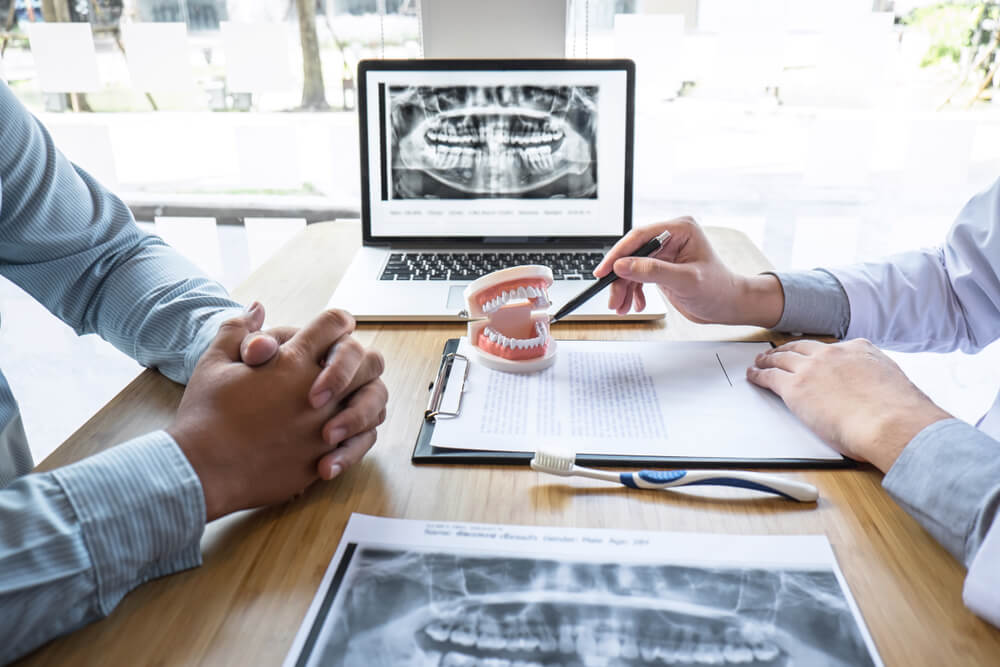 Professional Dentist and patient discussing jaw and teeth the x-ray