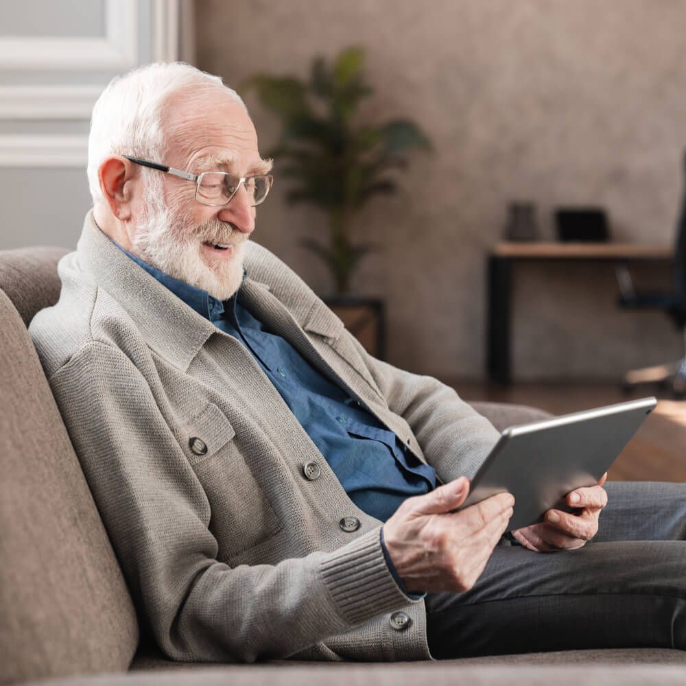 an old caucasian man grandfather using digital tablet