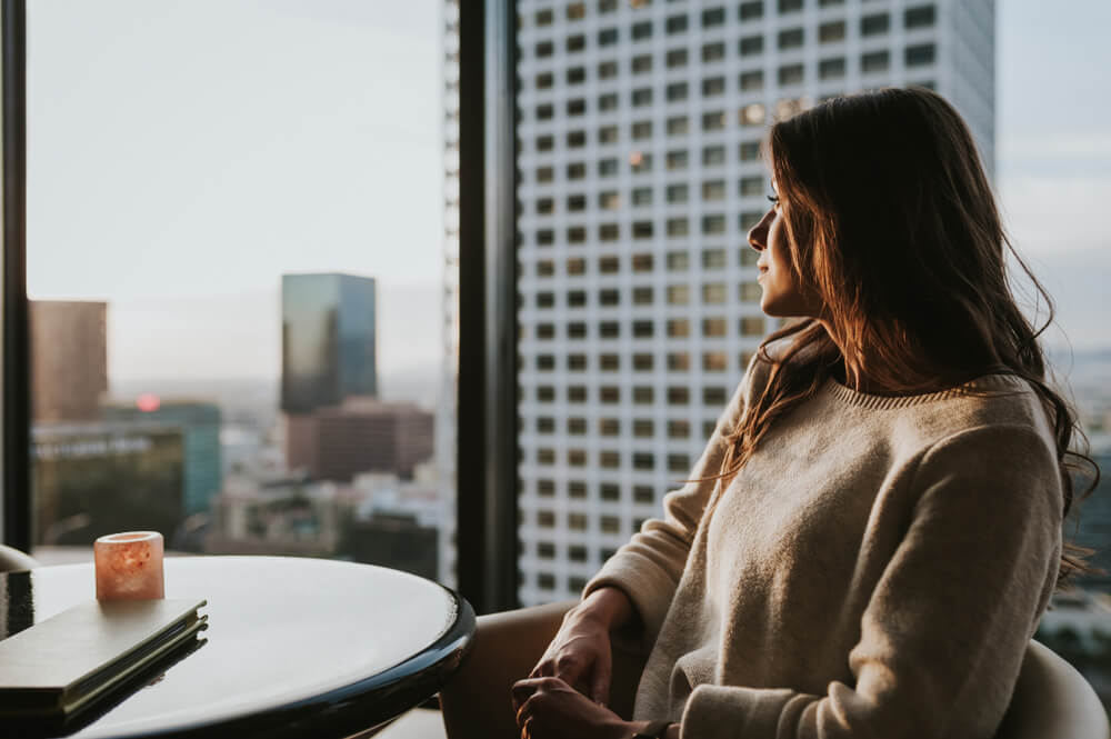 Young woman at restaurant on 35 floor, sitting at table