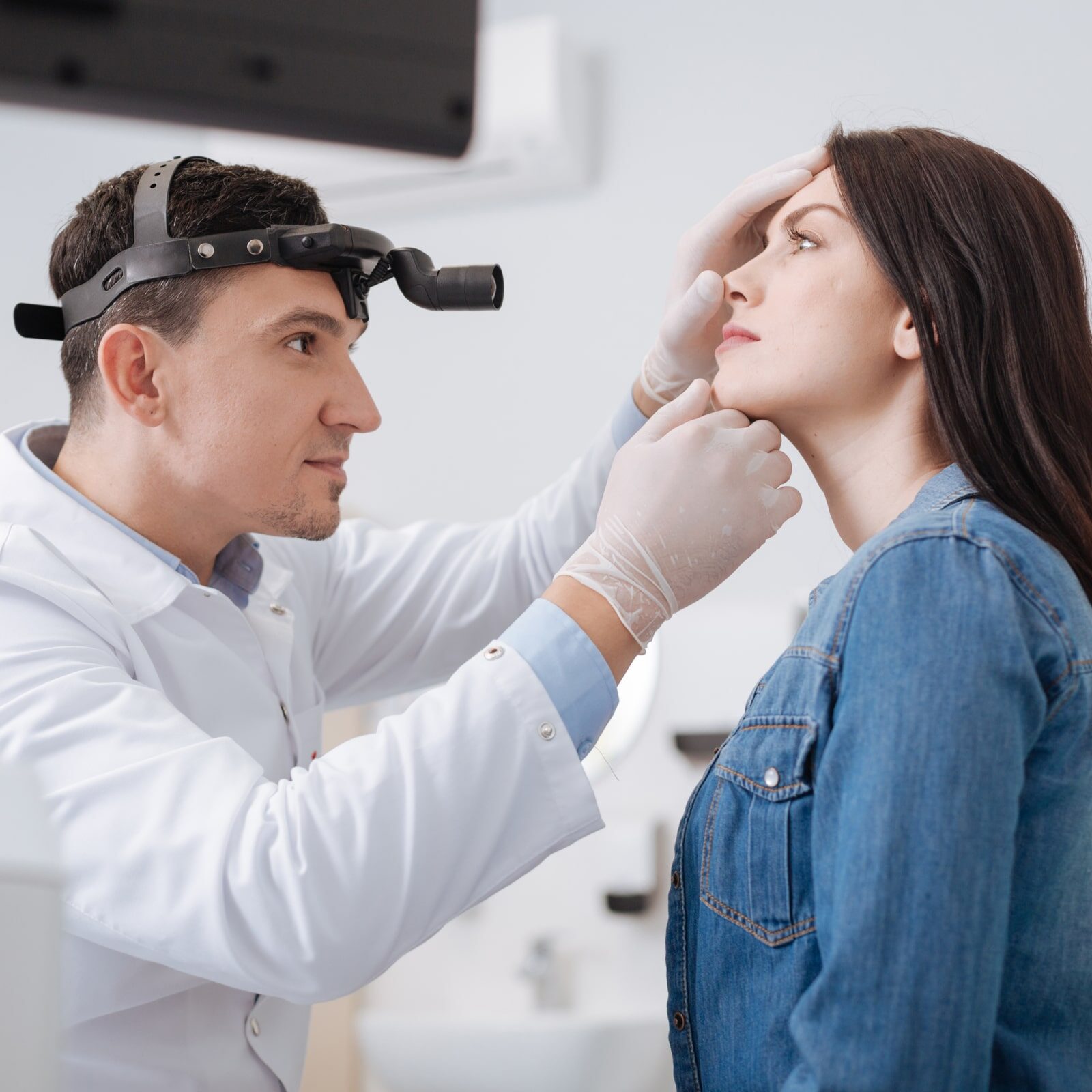 Portrait of otolaryngologist while working with patient