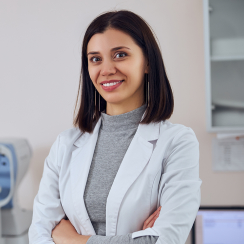 experienced doctor standing with crossed arms