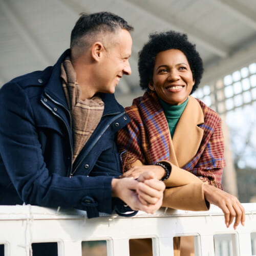 Happy multiracial couple spending winter day at the park