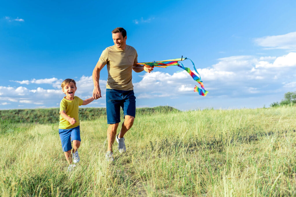 Cheerful parent having playtime with his son