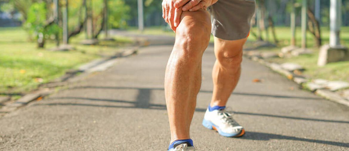 senior man stretching legs muscle before running or jogging