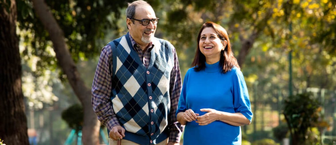 Happy senior couple admiring view at park