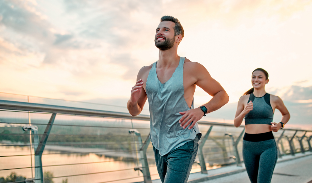 Couple doing sport together on the street. Morning run