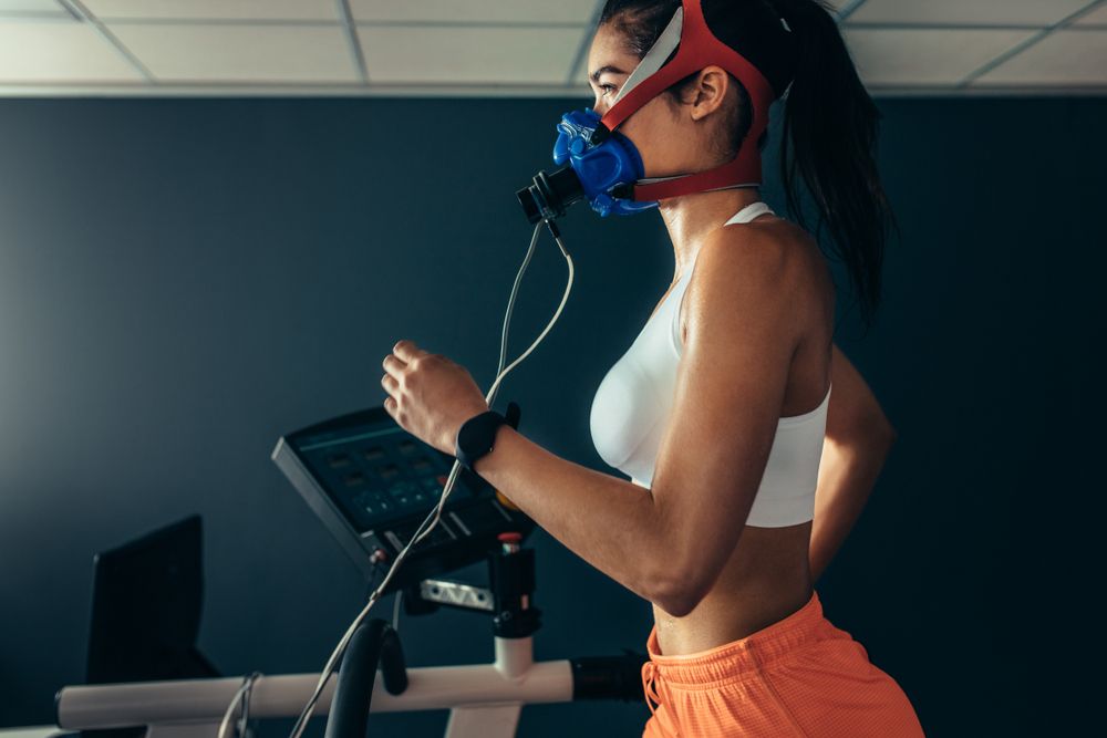 Side,View,Of,Professional,Sportswoman,With,Mask,Running,On,Treadmill