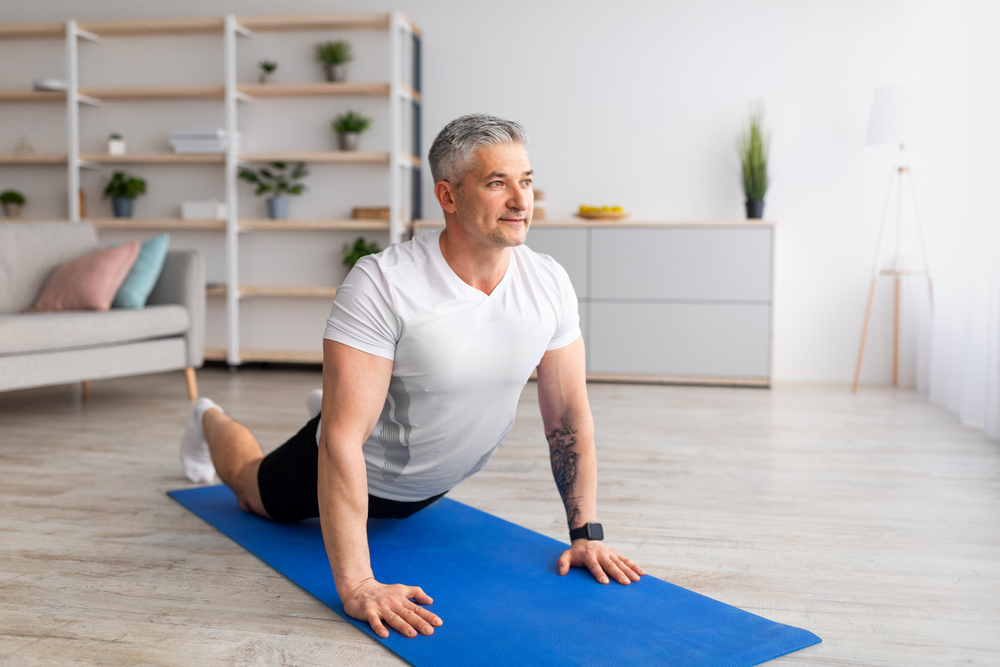 A man stretching to help his Parkinson's Disease symptoms. 