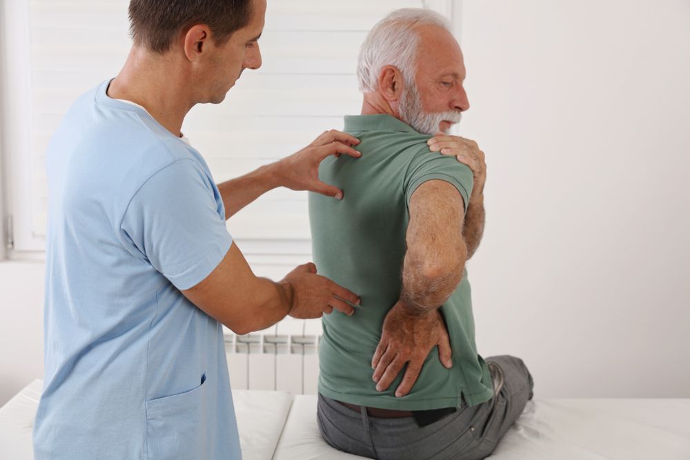 Man talking with doctor about chronic pain