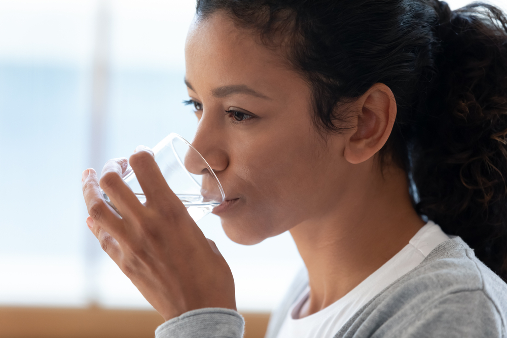 Woman drinking water to help with her balance problems