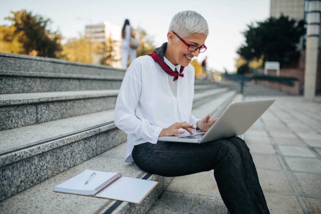 White haired mature lady working outside