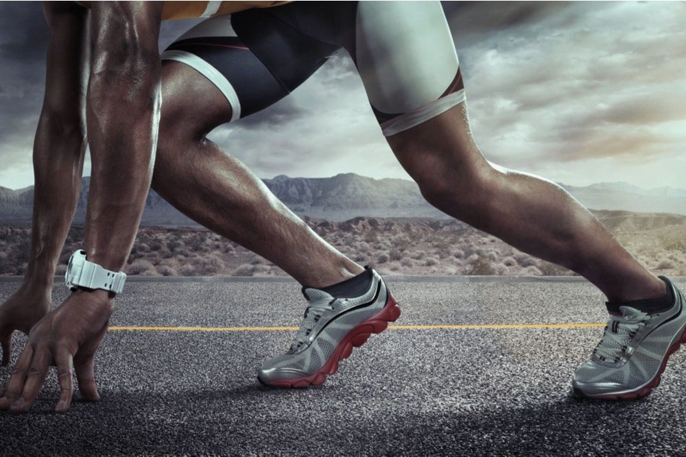 Runner feet running on road closeup on shoe.