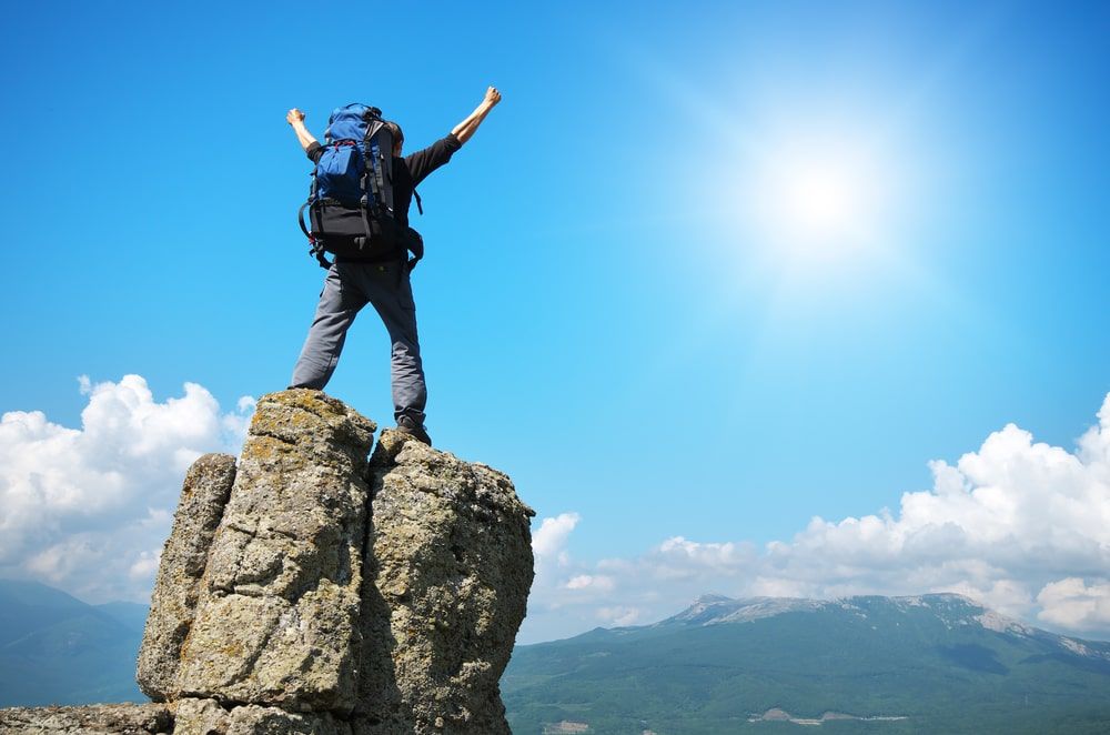 Man on peak of mountain