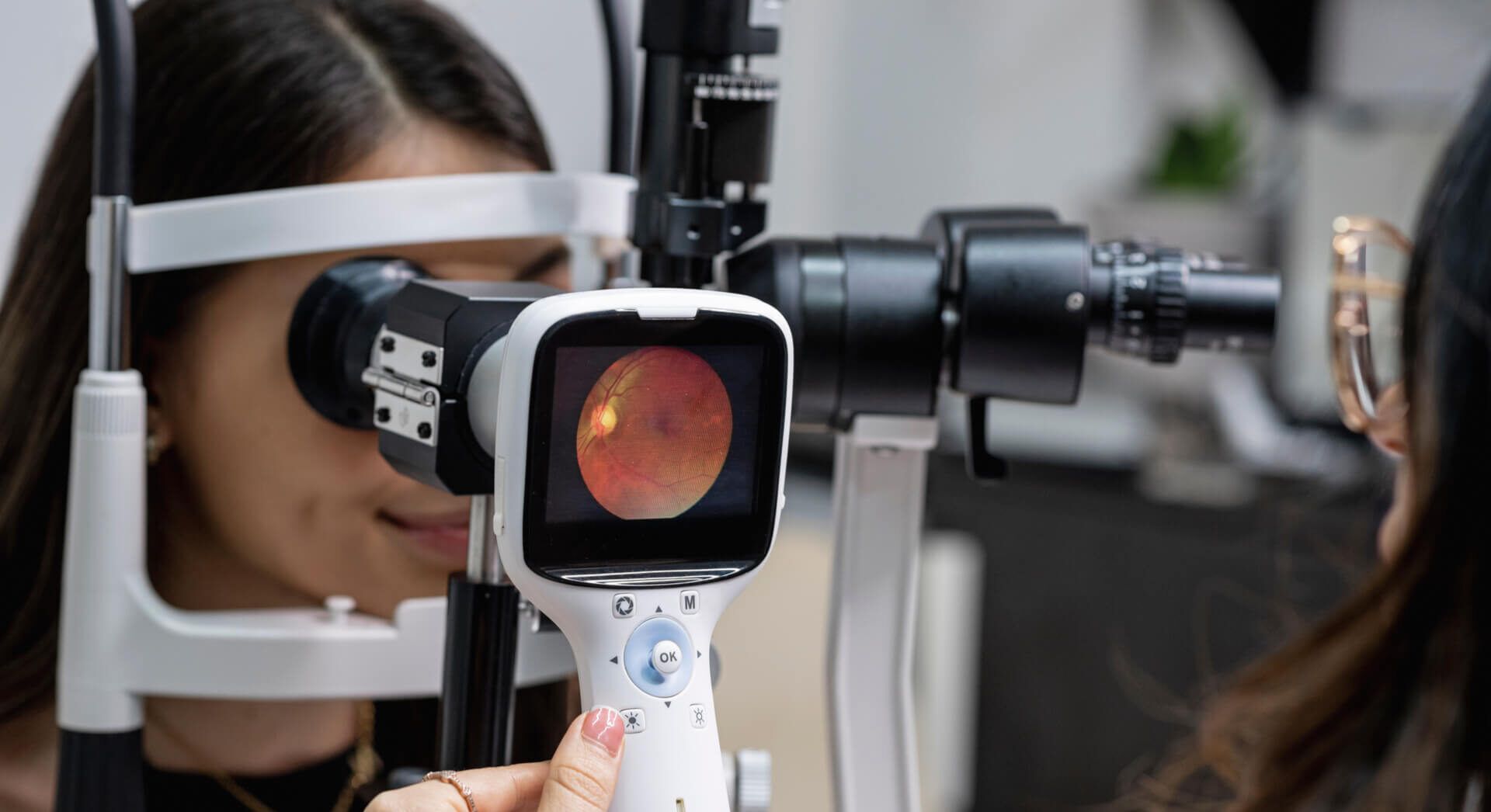 Eye doctor performing an eye fundus examination with retinal camera.