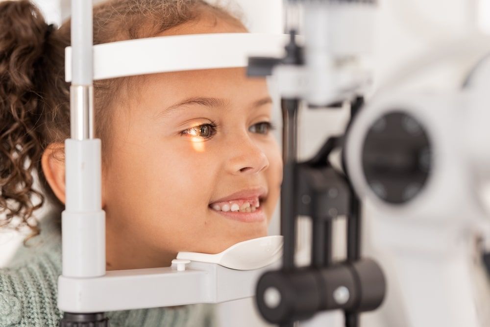 Vision, test and girl for eye exam in the opthalmologist office with equipment for glasses.