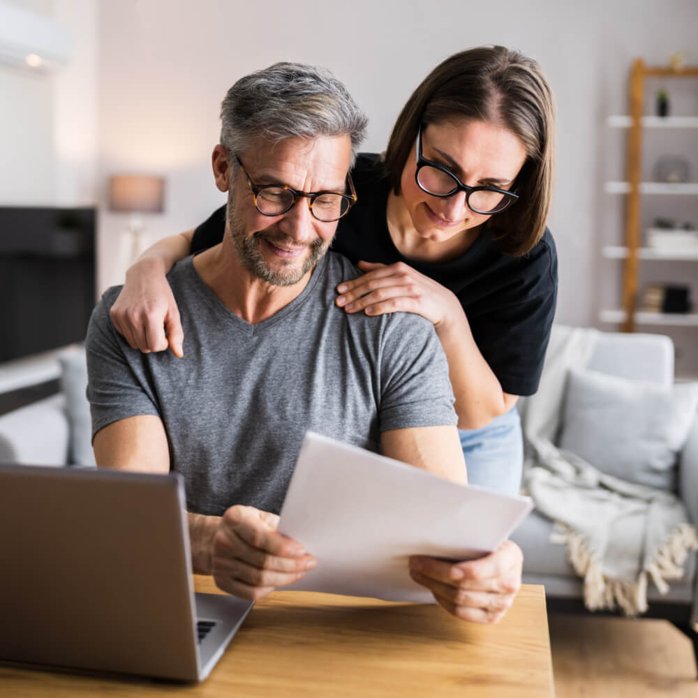 Couple Doing Taxes And Family Budget On Computer