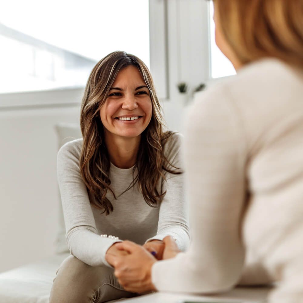 Smiling woman, talking to psychologist, feeling positive.