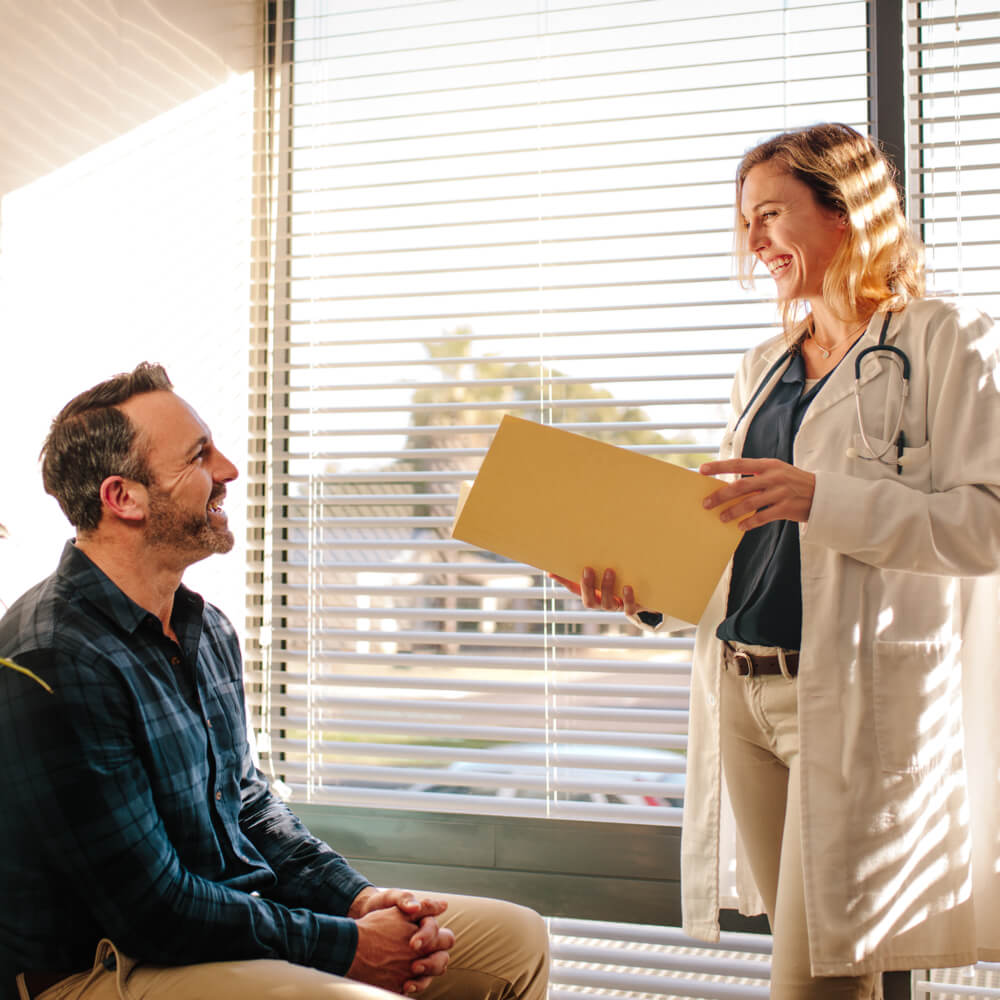 Smiling female doctor holding a medical report file