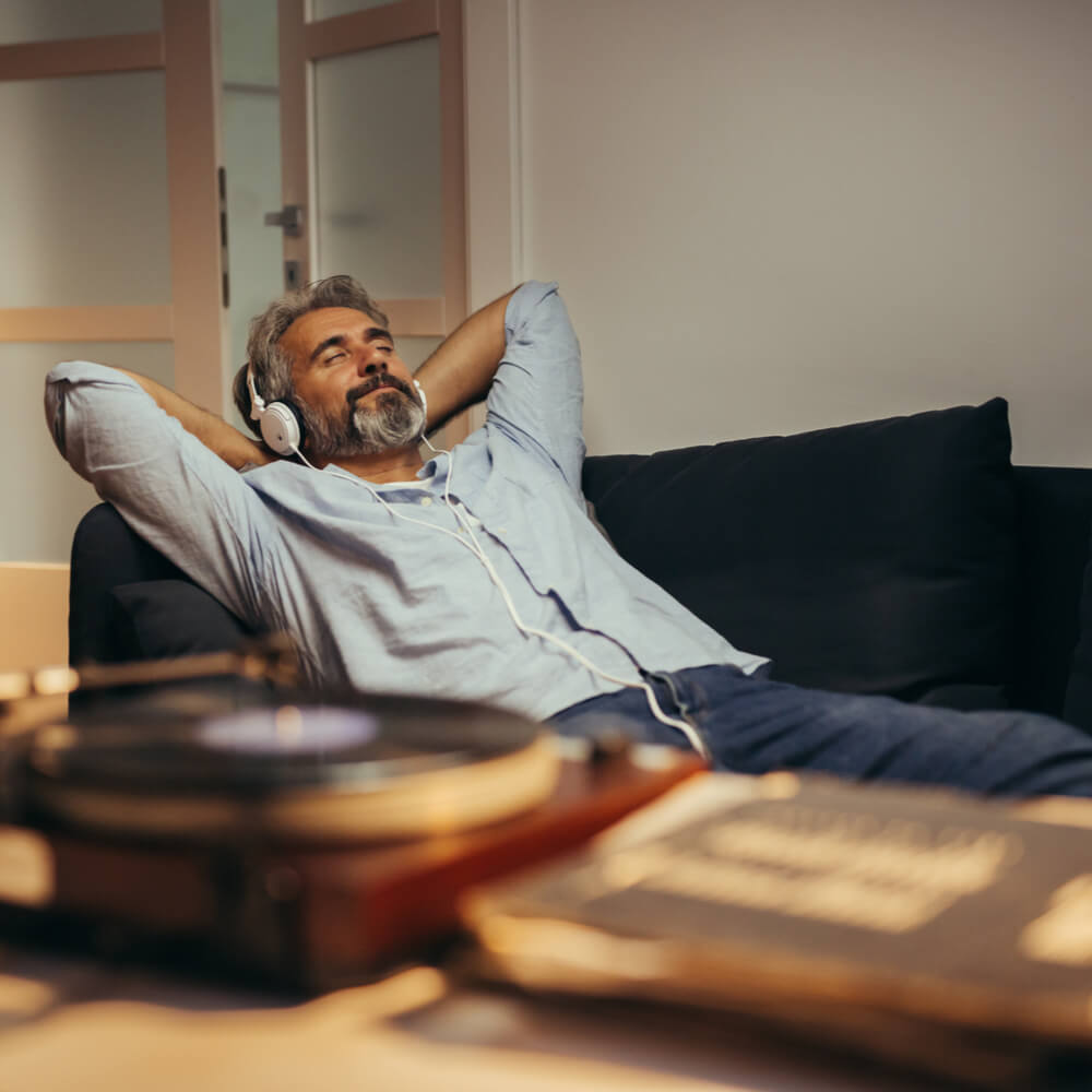 mid aged man listening music with headphones