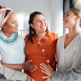 women touch stomach and support with smile