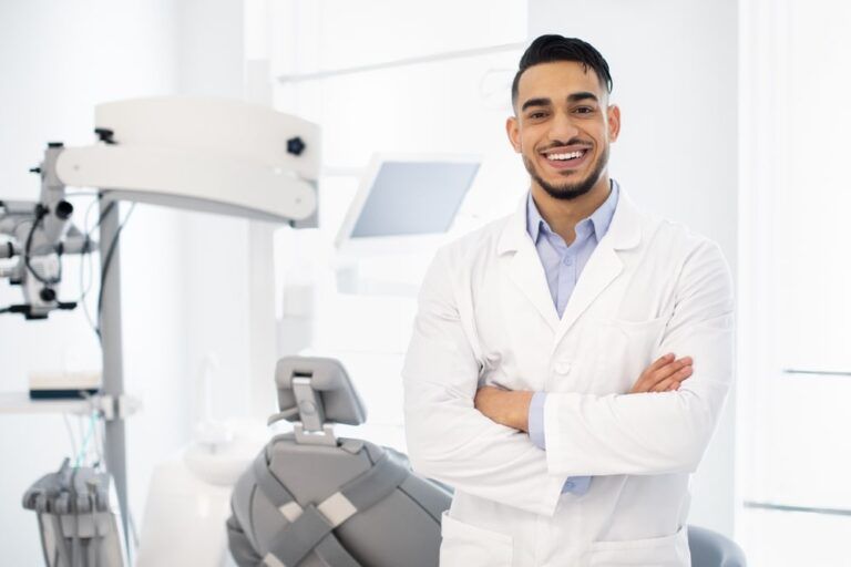 Smiling Dentist Doctor Posing At Workplace
