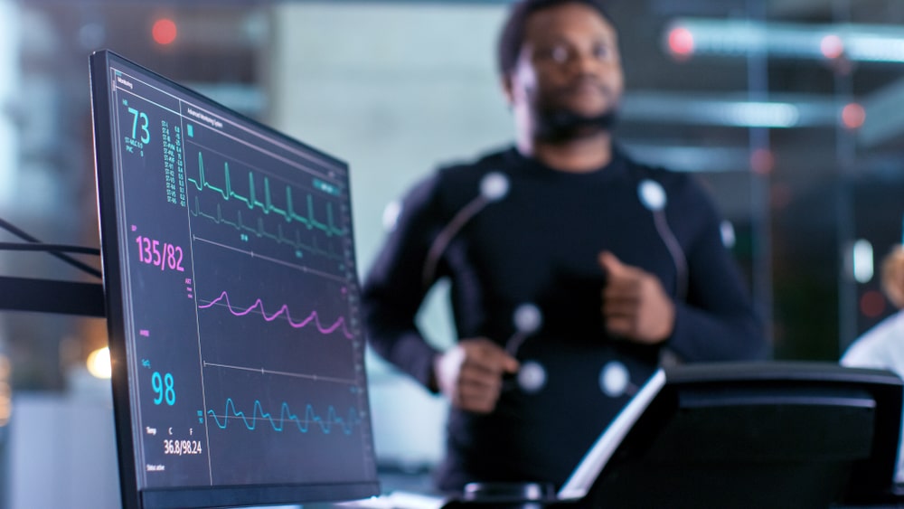 Male Athlete Runs on a Treadmill with Electrodes Attached