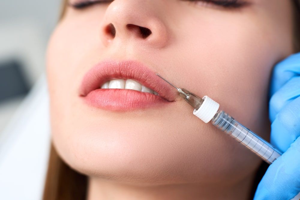 Doctor Hands Doing Beauty Procedure To Female Lips with Syringe