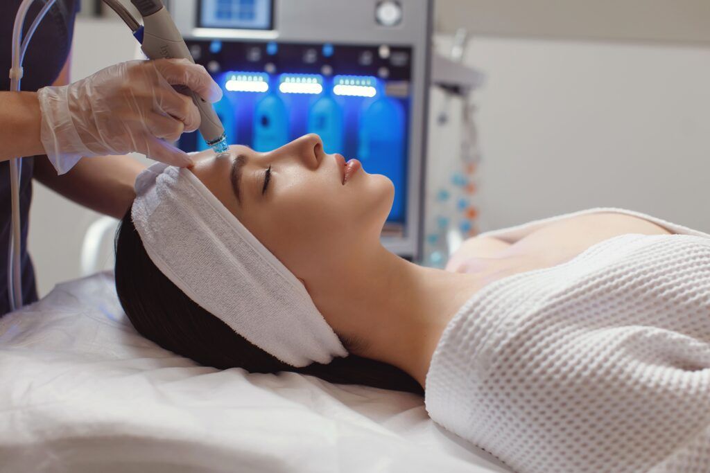 Side view of woman receiving microdermabrasion therapy