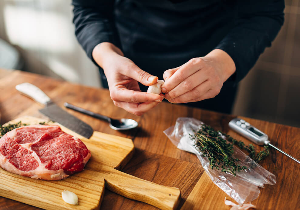 Overhead shot of chef preparing ribeye in a kitchen