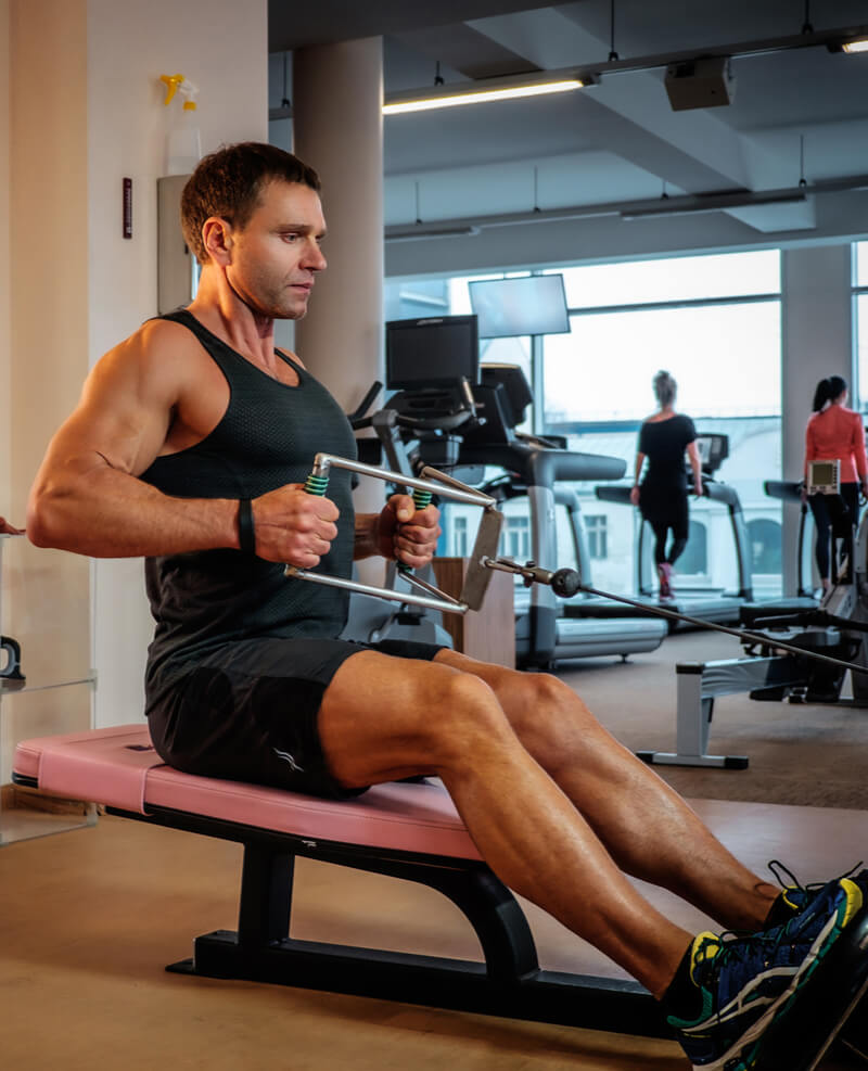 Middle age man doing workout in a gym club.