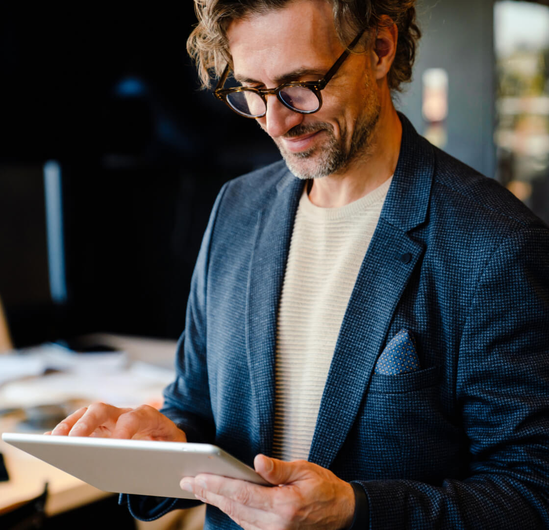 Mature manager using tablet computer during offline meeting in office