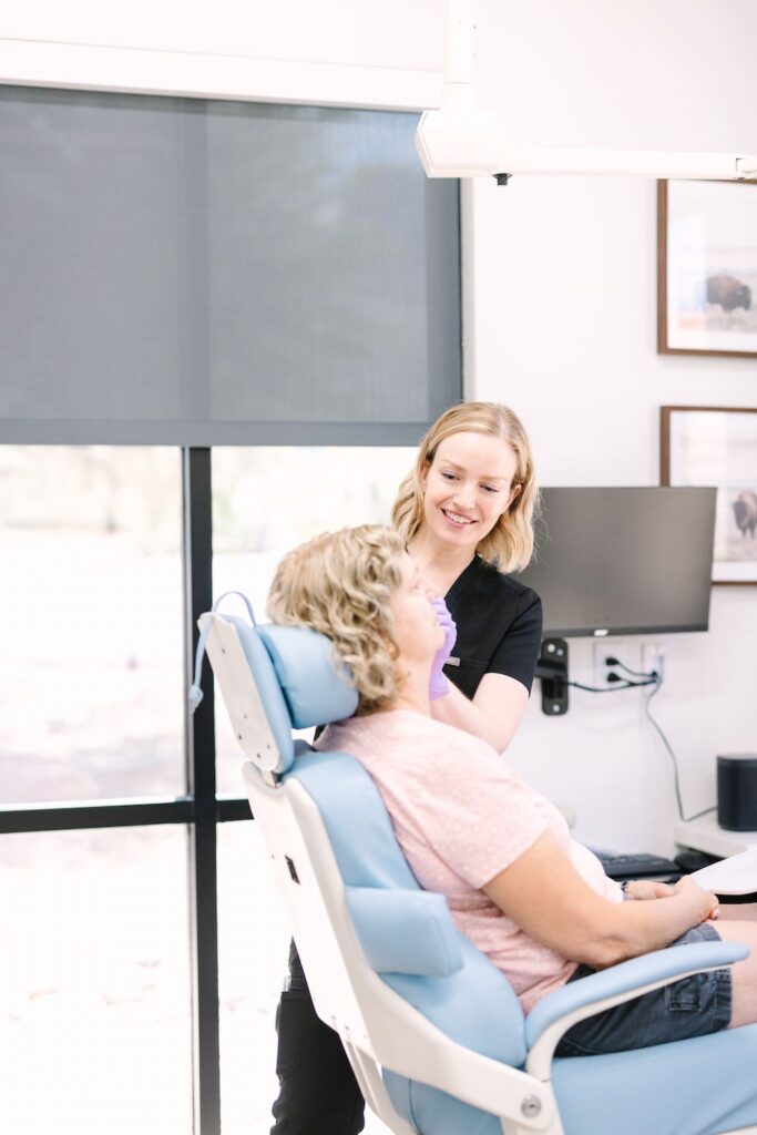 NATALIE UDEN MSN, FNP-C with patient during treatment process