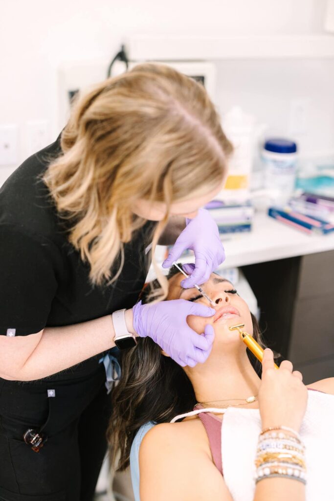 NATALIE UDEN MSN, FNP-C with patient during treatment process