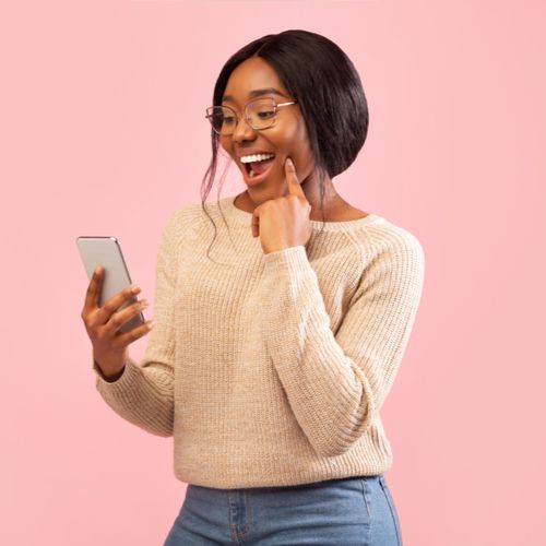 Excited African American Girl Using Smartphone