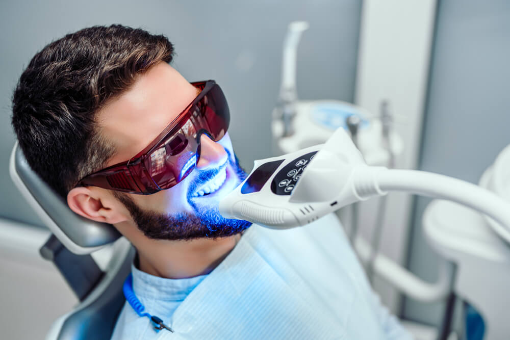 Man at clinic getting Zoom Teeth Whitening