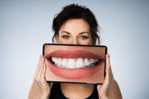 Woman With Dental Braces And Tablet