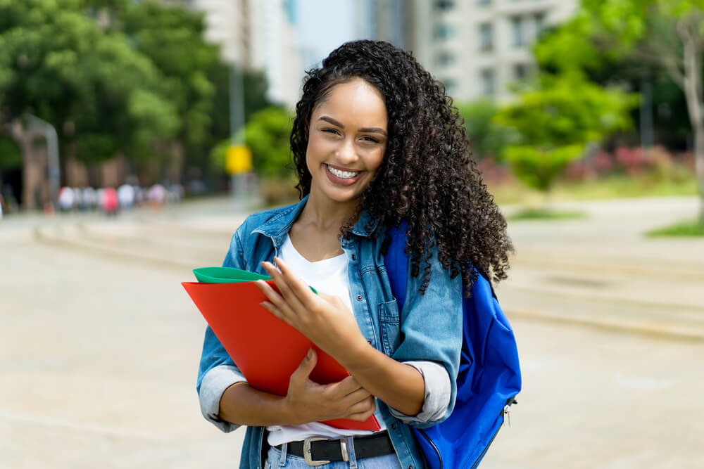 young adult student with retainer outdoor in summer in city