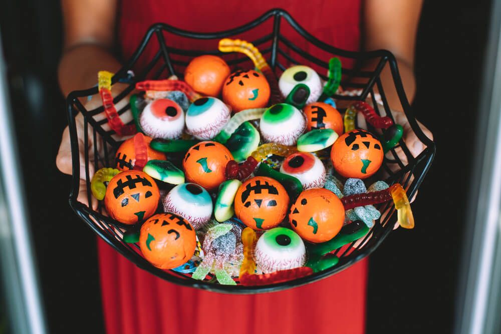 Woman offering funny Halloween candies