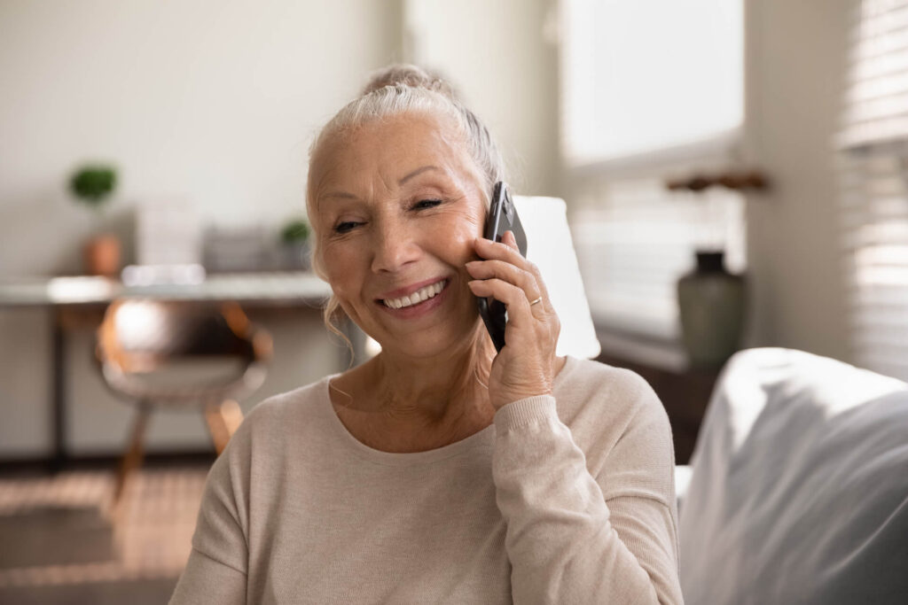 Woman speaking on the phone regarding office visits with Davis Family Orthodontics