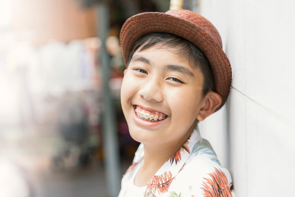 Teenager with teeth brace dental smiling