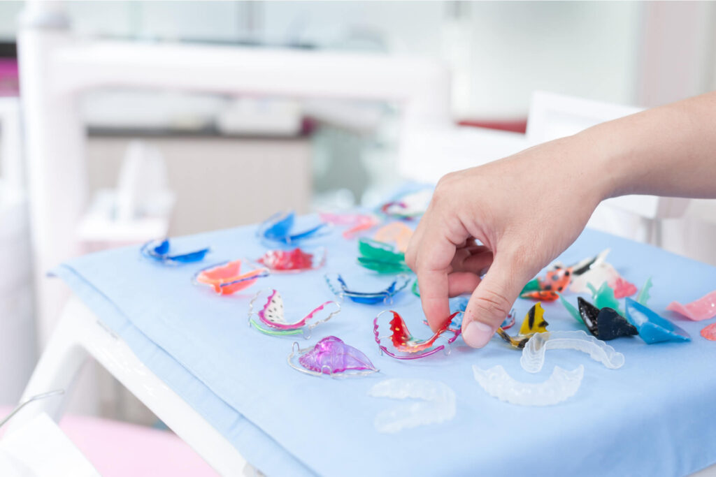 Dental braces or teeth retainers on table in dental clinic.