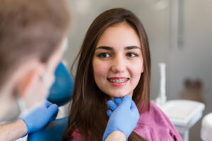 White Teeth. Closeup Portrait Of Beautiful Happy Woman With Perfect White Smile Using Teeth Whitening Tray