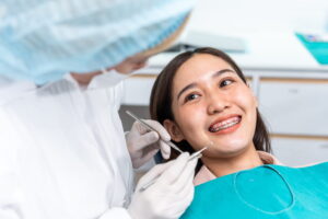 Orthodontist doctor examine tooth to woman patient at dental clinic