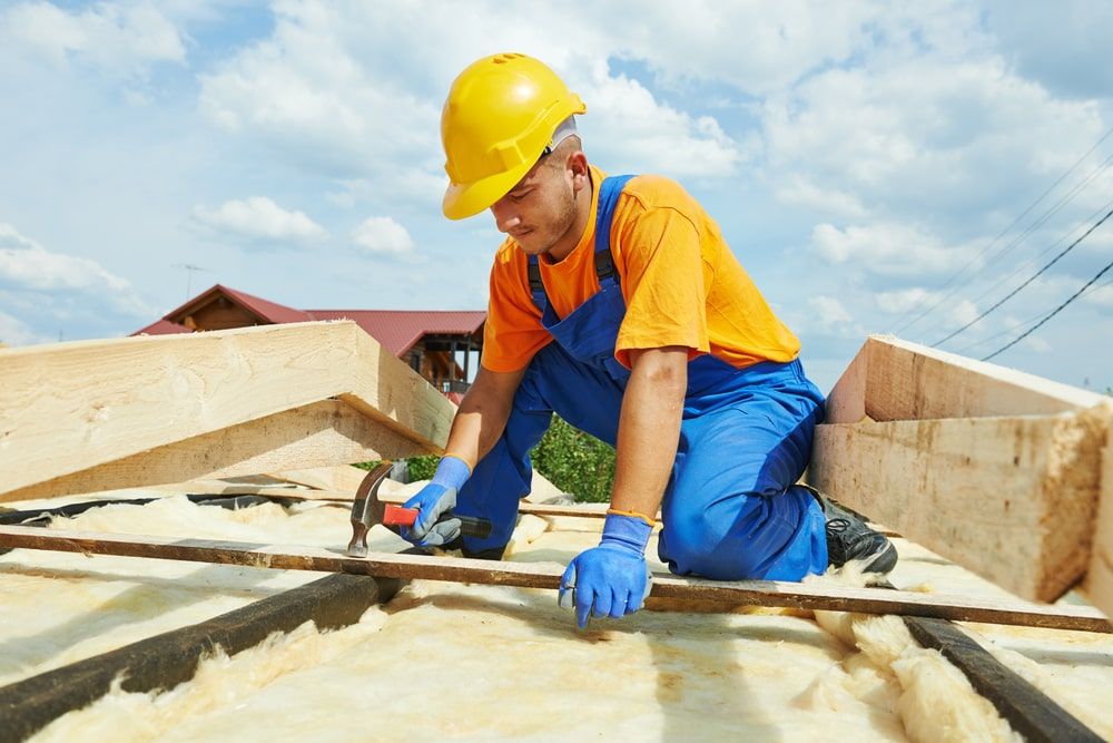 construction roofer carpenter worker hammering wood board