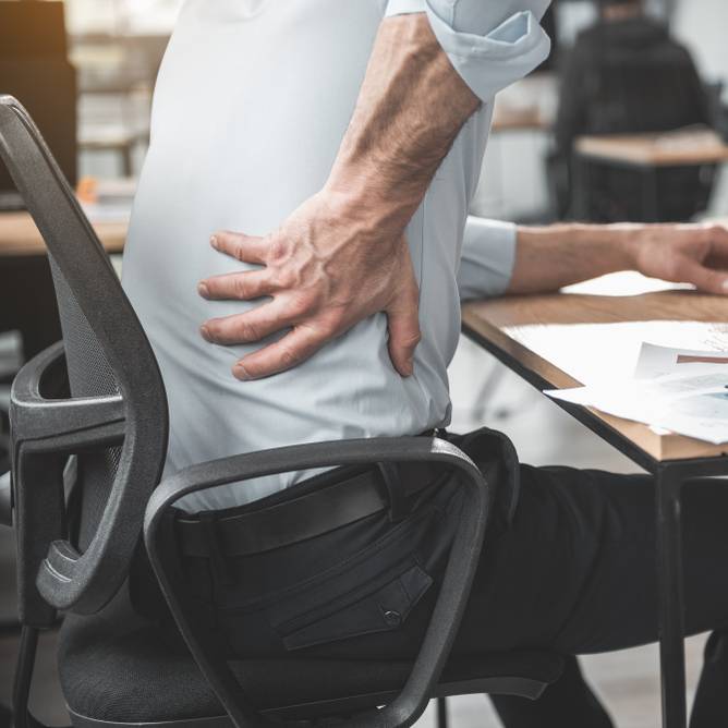 Man having pain in back at office