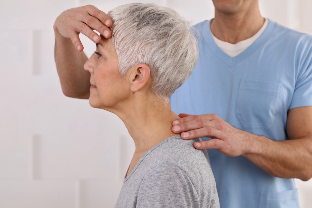 Mature Woman having chiropractic adjustment