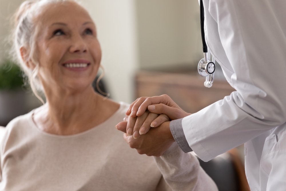 Happy senior woman visiting doctor